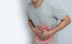 man-suffering-from-stomach-ache-with-both-palm-around-waistline-show-pain-injury-belly-area